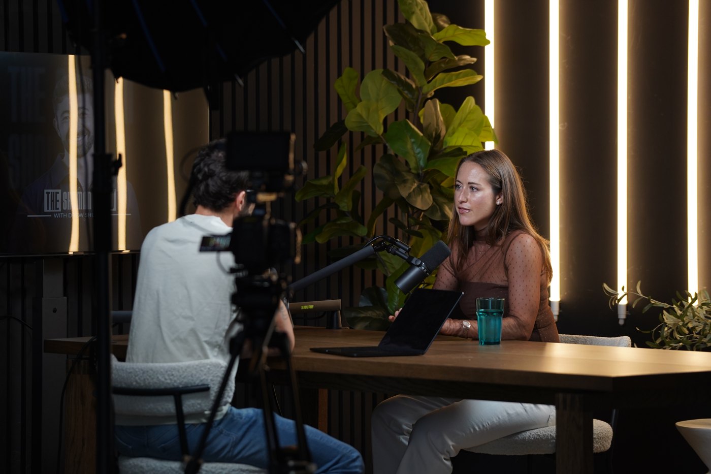 Brooke Robbins speaking with the host during a recording of The Shuman Show